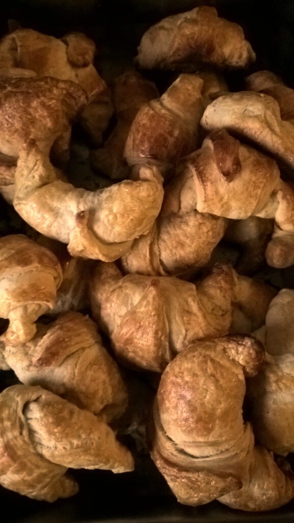 Golden croissants piled on a tray
